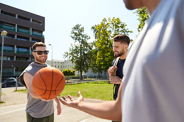 Image showing group of male friends playing street basketball