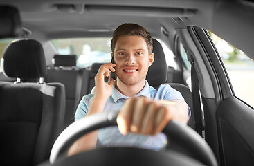 Image showing man driving car and calling on smartphone