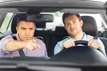 Image showing car driving school instructor teaching male driver