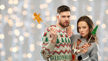 Image showing couple with christmas party props in ugly sweaters