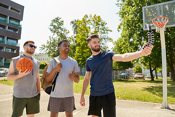 Image showing happy men taking selfie on basketball playground