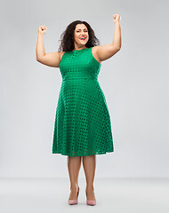 Image showing happy woman in green dress showing women power