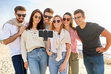 Image showing happy friends taking selfie on summer beach