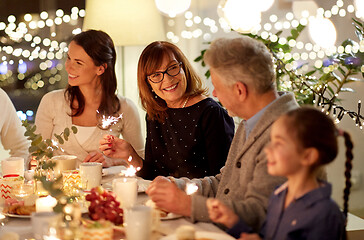 Image showing family with sparklers having tea party at home