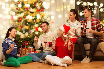 Image showing friends with sparklers celebrating christmas