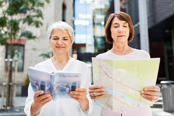 Image showing senior women with city guide and map on street