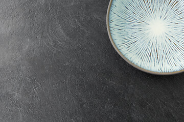 Image showing close up of blue ceramic plate on slate background