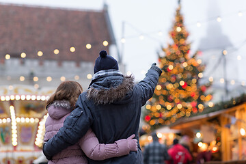 Image showing happy senior couple hugging at christmas market