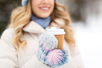 Image showing happy woman drinking coffee outdoors in winter