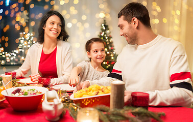 Image showing happy family having christmas dinner at home