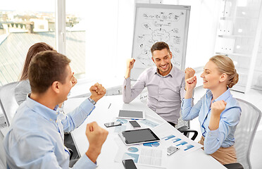 Image showing happy business team celebrating success at office