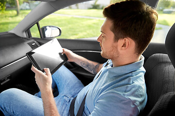 Image showing male passenger using tablet computer in taxi car