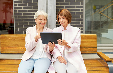 Image showing senior women with tablet computer in city