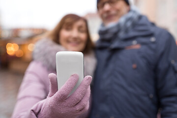 Image showing couple taking selfie by smartphone on christmas