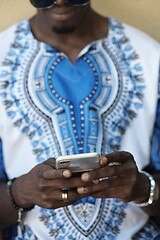 Image showing native african black man using smart phone