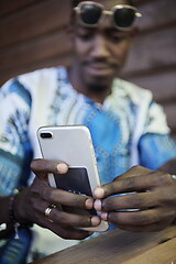 Image showing native african black man using smart phone