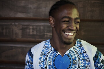 Image showing portrait of a smiling young african man wearing traditioinal clothes