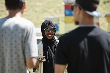 Image showing woman giving presentation to group of business investors on local honey production farm