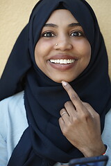 Image showing african woman using smartphone wearing traditional islamic clothes