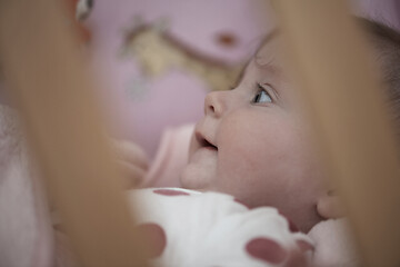 Image showing cute little baby playing with hands and smiling