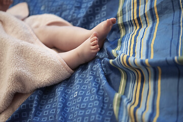 Image showing cute little baby playing with hands and smiling