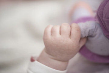 Image showing cute little baby playing with hands and smiling