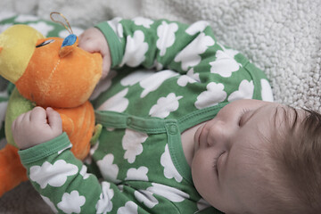 Image showing cute little baby playing with hands and smiling