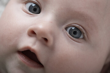 Image showing cute little baby playing with hands and smiling