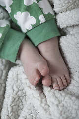 Image showing cute little baby playing with hands and smiling