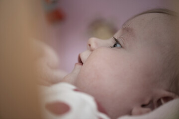 Image showing cute little baby playing with hands and smiling