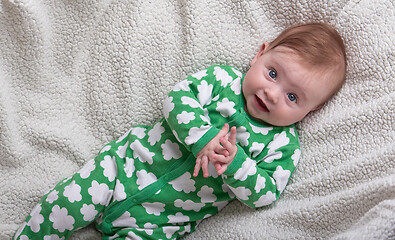 Image showing cute little baby playing with hands and smiling