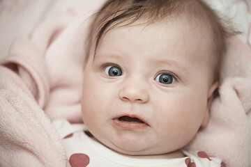 Image showing cute little baby playing with hands and smiling