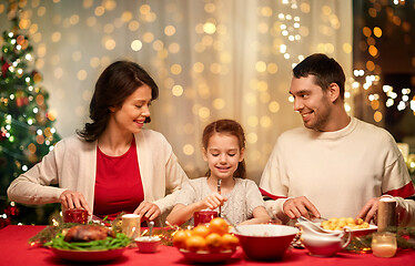 Image showing happy family having christmas dinner at home