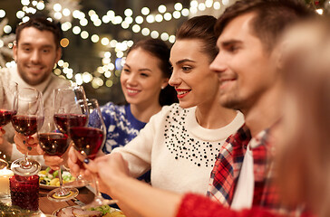 Image showing friends celebrating christmas and drinking wine
