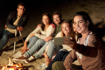 Image showing happy friends taking selfie at camp fire on beach