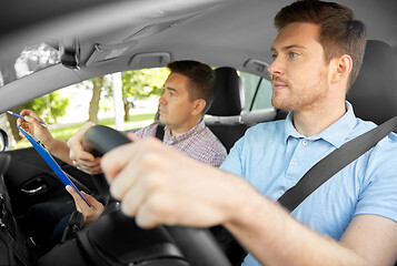 Image showing car driving school instructor and young driver