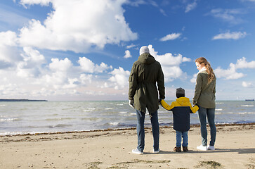 Image showing happy family at autumn beach looking at sea