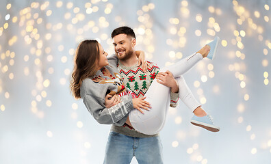 Image showing happy couple at christmas ugly sweater party