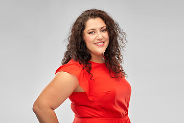 Image showing happy woman in red dress over grey background