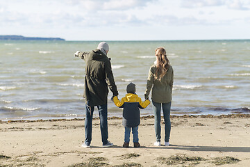Image showing happy family at autumn beach looking at sea