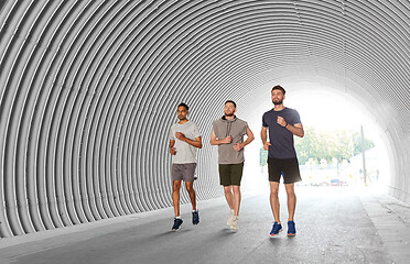 Image showing young men or male friends running outdoors