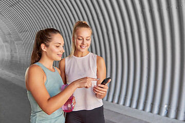 Image showing women or female friends with smartphone and flask