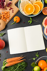 Image showing close up of notebook, fruits and vegetables