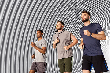 Image showing young men or male friends running outdoors