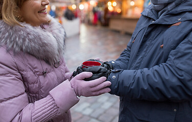 Image showing senior couple with mulled wine at christmas market