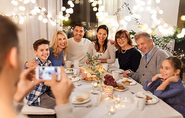 Image showing family having dinner party and taking selfie