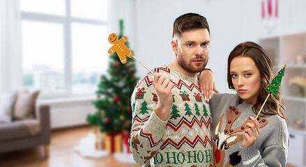 Image showing couple with christmas party props in ugly sweaters