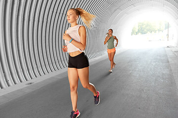 Image showing young women or female friends running outdoors