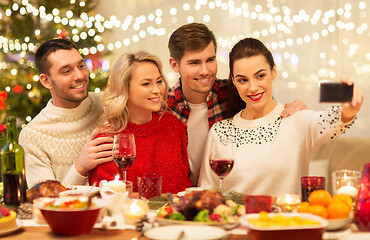 Image showing friends taking selfie at christmas dinner