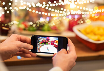 Image showing hands photographing food at christmas dinner